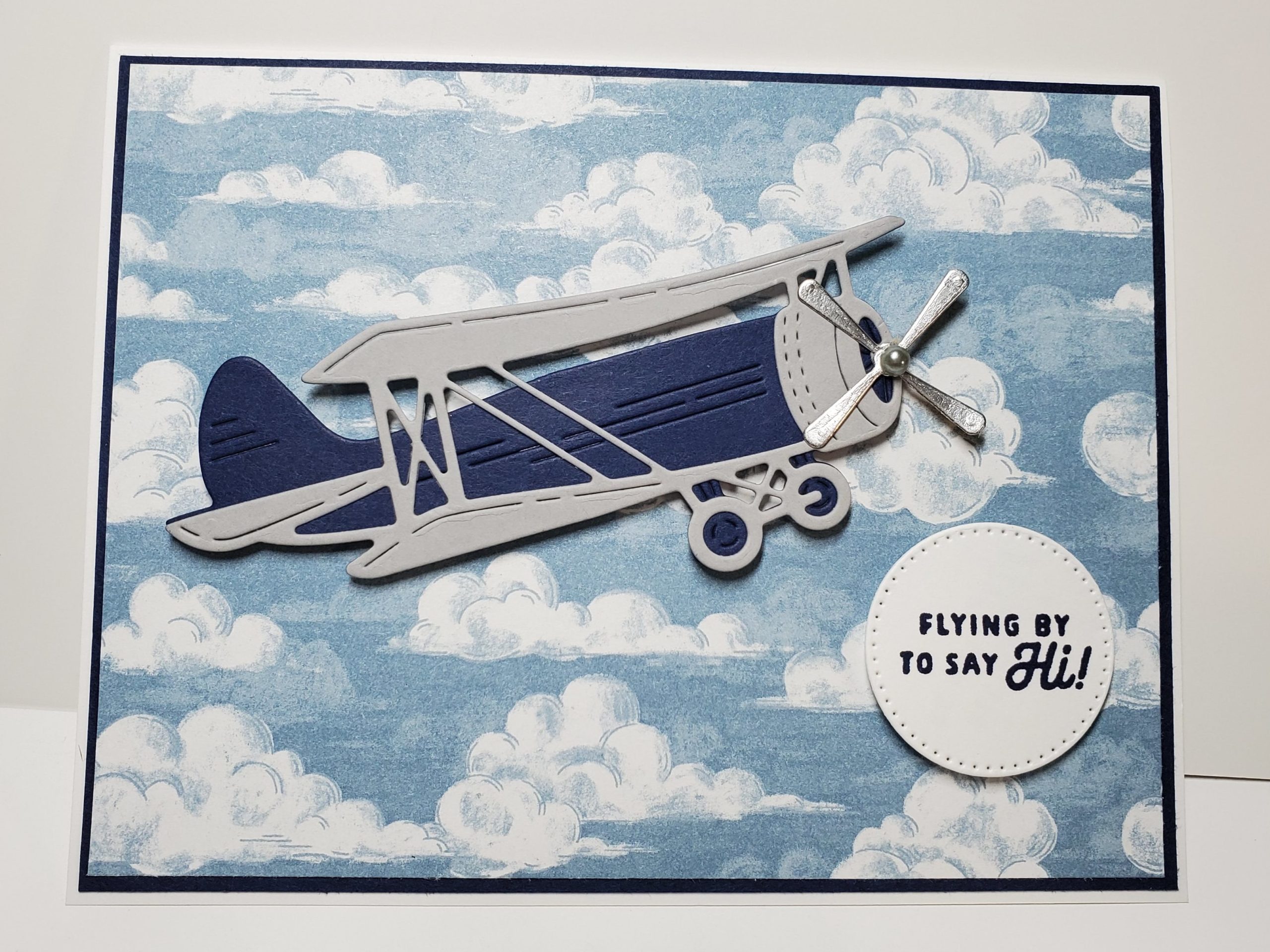 Masculine card with die cut airplane on sky background.